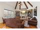 Cozy living room features a stone fireplace, beamed ceilings, and custom built-in shelving units at 5640 Copper Creek Pass, Cumming, GA 30040