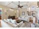 Spacious living room with hardwood floors, a fireplace, and ample seating for entertaining guests at 5640 Copper Creek Pass, Cumming, GA 30040
