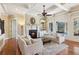 Elegant living room with coffered ceilings, fireplace, and built-in shelving, creating a cozy atmosphere at 5640 Copper Creek Pass, Cumming, GA 30040