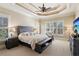 Relaxing main bedroom with tray ceilings, plantation shutters and a ceiling fan to keep you comfortable at 5640 Copper Creek Pass, Cumming, GA 30040