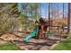 Backyard featuring a wooden playset with a slide, swings, and playhouse area at 5640 Copper Creek Pass, Cumming, GA 30040