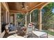 Covered porch with comfortable seating, perfect for relaxing and enjoying the outdoor views at 5640 Copper Creek Pass, Cumming, GA 30040