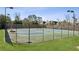 Community tennis courts fenced in with lighting and manicured landscaping at 5640 Copper Creek Pass, Cumming, GA 30040