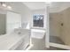 Elegant bathroom showcasing a modern soaking tub, walk-in shower, and a double sink vanity at 6719 Winterberry Ridge Dr, Stone Mountain, GA 30087