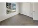 Carpeted bedroom with natural light and view of a neighboring home at 6719 Winterberry Ridge Dr, Stone Mountain, GA 30087
