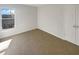 Bright bedroom with neutral carpet, white walls, window, and closet at 6719 Winterberry Ridge Dr, Stone Mountain, GA 30087