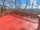 Outdoor living space with a freshly stained, red wooden deck and natural views at 6719 Winterberry Ridge Dr, Stone Mountain, GA 30087
