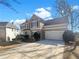 Inviting two-story home featuring a two-car garage, well-manicured landscaping, and a classic facade at 6719 Winterberry Ridge Dr, Stone Mountain, GA 30087