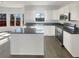 Bright kitchen featuring stainless steel appliances, sleek granite countertops, and white cabinets at 6719 Winterberry Ridge Dr, Stone Mountain, GA 30087