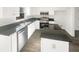 Bright kitchen featuring stainless steel appliances, sleek granite countertops, and white cabinets at 6719 Winterberry Ridge Dr, Stone Mountain, GA 30087