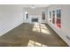 Bright living room featuring a cozy fireplace and lots of natural light from large windows at 6719 Winterberry Ridge Dr, Stone Mountain, GA 30087