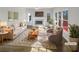 Bright living room showcasing neutral colors, a cozy fireplace, and lots of natural light from large windows at 6719 Winterberry Ridge Dr, Stone Mountain, GA 30087