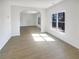 Open living room with natural light, arched doorway, and wood floors at 6719 Winterberry Ridge Dr, Stone Mountain, GA 30087