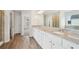 This bathroom features a walk-in shower, and double sink vanity with granite countertops at 1452 Stephens View Dr, Loganville, GA 30052