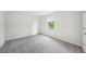 Bright bedroom with a neutral carpet, large window and white walls at 1452 Stephens View Dr, Loganville, GA 30052