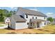 A captivating backyard view featuring a spacious home with a covered patio and lush green landscape, ideal for relaxation at 1452 Stephens View Dr, Loganville, GA 30052