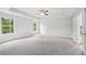 This large main bedroom features neutral carpeting, large windows and a ceiling fan at 1452 Stephens View Dr, Loganville, GA 30052