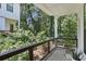 Cozy outdoor balcony with wood and metal railing overlooking a private backyard surrounded by mature trees at 321 Dilbeck Ne Cir, Atlanta, GA 30342