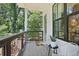 Outdoor balcony with metal and wood railing, offering a tranquil view of lush green trees at 321 Dilbeck Ne Cir, Atlanta, GA 30342