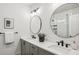 Elegant bathroom with double sinks, granite countertops, round mirrors, and a glass-enclosed shower at 321 Dilbeck Ne Cir, Atlanta, GA 30342
