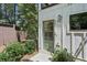 Charming front entrance with a green door, lush landscaping, and tasteful exterior lighting at 321 Dilbeck Ne Cir, Atlanta, GA 30342