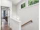 Upstairs hallway featuring white walls, a wood railing, and hardwood floors leading to other rooms at 321 Dilbeck Ne Cir, Atlanta, GA 30342