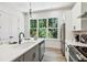 Modern kitchen with island, stainless steel appliances, and view-through window at 321 Dilbeck Ne Cir, Atlanta, GA 30342