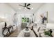 Open-concept living room featuring a ceiling fan, hardwood floors, and seamlessly connected kitchen at 321 Dilbeck Ne Cir, Atlanta, GA 30342