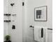 Modern walk-in shower featuring white subway tile, black hardware, and built-in shelves at 321 Dilbeck Ne Cir, Atlanta, GA 30342