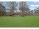 Large backyard with a lush green lawn, mature trees, and fencing for privacy and safety at 4165 Azurite St, Cumming, GA 30040
