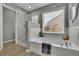 This bathroom has a bathtub, glass shower, and window at 4165 Azurite St, Cumming, GA 30040