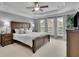 Beautiful bedroom features a tray ceiling, carpet flooring, and a ceiling fan at 4165 Azurite St, Cumming, GA 30040