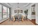 Elegant dining room with tray ceilings, wainscoting, and large windows overlooking the backyard at 4165 Azurite St, Cumming, GA 30040