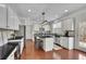 Bright, renovated kitchen with an island, stainless steel appliances, and access to the outdoor deck at 4165 Azurite St, Cumming, GA 30040