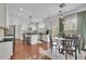 Spacious eat-in kitchen with white cabinets, stainless appliances, and a view to the breakfast table at 4165 Azurite St, Cumming, GA 30040
