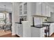 Kitchen view highlighting the built-in desk space with white cabinets, drawers and black countertop at 4165 Azurite St, Cumming, GA 30040
