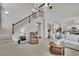 Open-concept living space with a staircase and comfortable seating, perfect for relaxing and entertaining guests at 4165 Azurite St, Cumming, GA 30040