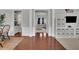 Connected living spaces showcasing hardwood flooring and views into the dining room and playroom at 4165 Azurite St, Cumming, GA 30040