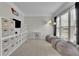 Versatile playroom area with built-in storage, neutral carpeting, and ample space for activities at 4165 Azurite St, Cumming, GA 30040