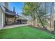 Backyard features artificial turf and a covered hot tub area, perfect for outdoor relaxation at 5890 Kayron Dr, Atlanta, GA 30328