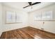 Bright bedroom with wood floors, ceiling fan, windows with shutters, and natural light at 5890 Kayron Dr, Atlanta, GA 30328