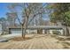Well-maintained single-story home featuring a spacious front yard, attached garage, and inviting front entrance at 5890 Kayron Dr, Atlanta, GA 30328