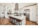 Well-lit kitchen showcases white cabinets, stainless steel appliances, gas cooktop, and island with seating at 5890 Kayron Dr, Atlanta, GA 30328