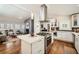 Open concept showing a modern kitchen with stainless steel appliances and island, flowing into the living room at 5890 Kayron Dr, Atlanta, GA 30328