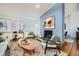 Comfortable living room featuring a brick fireplace, hardwood floors, stylish seating, and bright windows at 5890 Kayron Dr, Atlanta, GA 30328