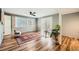Spacious living room with brick accent wall, ceiling fan and wood-look floors at 5890 Kayron Dr, Atlanta, GA 30328