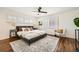 Bright main bedroom with hardwood floors, ceiling fan, shutters, and a cozy sitting area at 5890 Kayron Dr, Atlanta, GA 30328