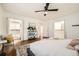 Spacious main bedroom featuring hardwood floors, walk-in closets, and a ceiling fan at 5890 Kayron Dr, Atlanta, GA 30328