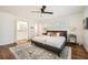Cozy main bedroom showcasing hardwood floors, a ceiling fan, and and walk-in closets at 5890 Kayron Dr, Atlanta, GA 30328