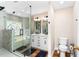 Elegant bathroom featuring a glass-enclosed tub with decorative tile work and double sink vanity at 6604 Destiny Se Dr, Mableton, GA 30126